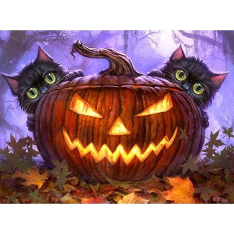 Halloween kittens behind a pumpkin